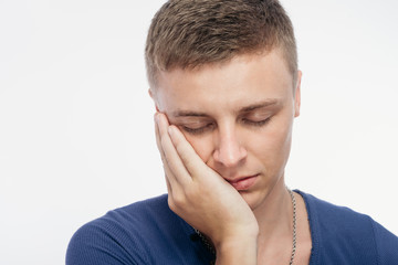 Sad young man covered his face with his hand