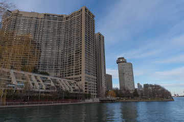 Obraz premium Generic day time exterior establishing shot of luxury high rise apartment condo building on calm waterfront in winter time. Canadian setting location