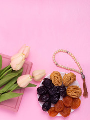 Flatley with rosaries, sweets, dates and tulips. The Concept Of Ramadan.