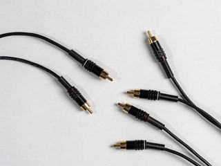 various audio connectors with cables on white background