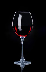 Crystal glass of wine on a black background in the studio