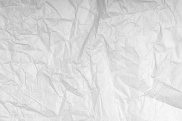 Obraz premium White wrinkled creased paper texture. Blank crumpled grainy paper textured surface. Smudged grungy grey poster. Close up. Material tissue for packing.