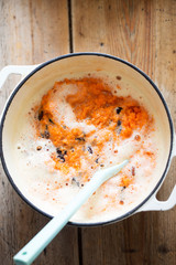 Carrot cake batter with beaten eggs, grated carrots & raisins