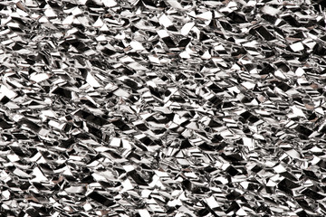 Silver crumpled metal foil texture. Metal glossy surface background.