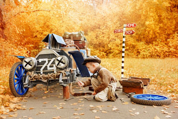 Young mechanic near an old race car