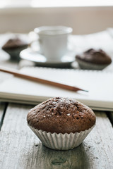Coffee and muffins, notepad and pencil