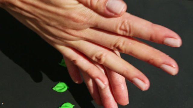 top view closeup on female hands form small marzipan peach colored ball
