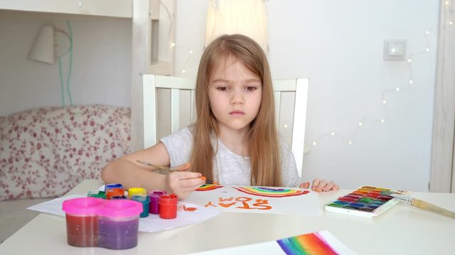 little girl with blond hair drew a rainbow and a poster stay home. flashmob chasetherainbow.