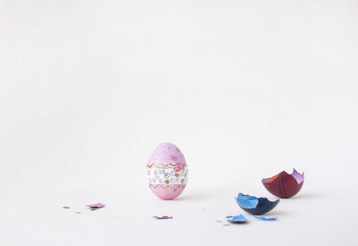 There are colored eggs on the stand. Real hand-painted eggs. Multi-face photo. On the white photo, funny cute faces on eggs. Holiday and joy of bright Easter