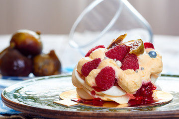 Dessert Pavlova with raspberries and figs on plate