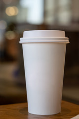 Mock-up of without Cup sleeve White paper hot coffee cup in Coffee shop./Food packaging pattern.