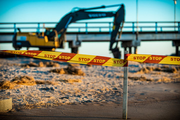 Stop line on the beach excavator digging sand 
