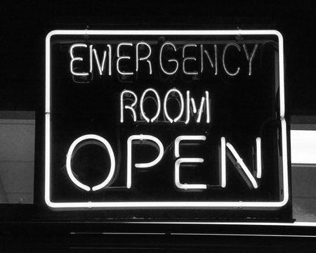 Filtered image open neon or led sign of an emergency room illuminated at night in America
