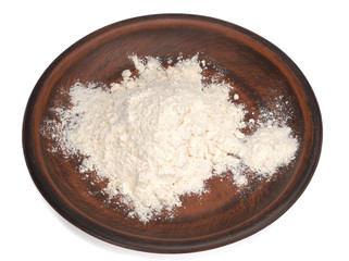 wheat flour in a plate on a white background