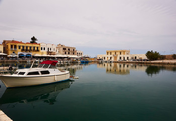 Fototapeta na wymiar RETHYMNO, THE CRETE ISLAND, GREECE - MAY 30, 2019: The view at the seaharbour of Rethymno.