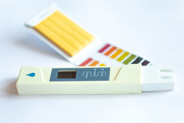 Litmus pH test with color scale and digital conductivity tester