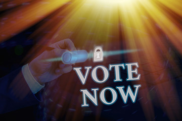 Conceptual hand writing showing Vote Now. Concept meaning formal indication of choice between two...