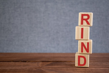 Abbreviation RIND (reversible ischemic neurologic deficit) text acronym on wooden cubes on dark wooden backround. Medicine concept.