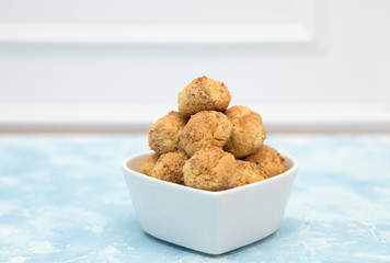 Tasty sugar cookies balls on wooden table.