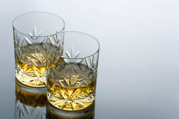 Two Glasses  of Whisky on a Reflective Surface with Copy Space