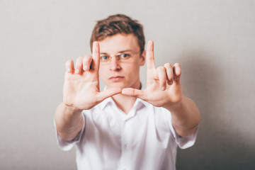 young guy making a frame arms