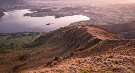 View on valley with lake during sunrise. Shot made on Roys Peak summit in Wanaka, New Zealand