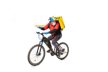 Too much orders. Contacless delivery service during quarantine. Man delivers food during isolation, wearing gloves and face mask. Taking pizza on bike isolated on white background. Safety. Hurrying up