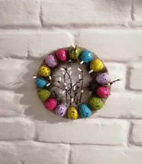 Handmade colorful eggs in a nest for Easter celebration