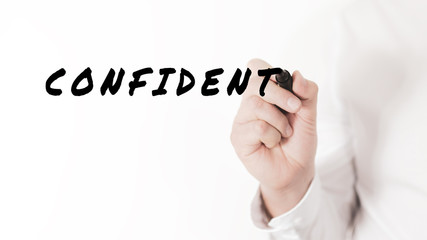Hand of a businessman writing a word Confident with black marker in a conceptual image of efficiency and performance
