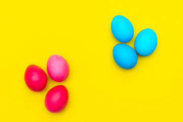 Colored painted eggs on a yellow background. Easter banner. Festive banner with place for text. Religious holiday.