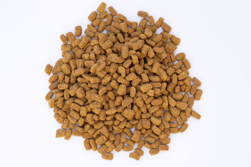 Dry cat food on a white background. Brown granules of dry food for adult sterilized cats. Small granules with turkey flavor food for domestic cats.
