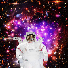 Astronaut and galaxy on the backdrop. The elements of this image furnished by NASA.