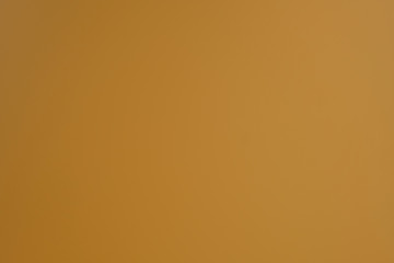 Light brown background. Dark yellow abstract background. Simple background with soft gradient.