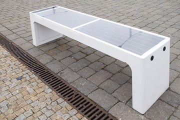 Bench with solar battery to power wifi and charge mobile devices.