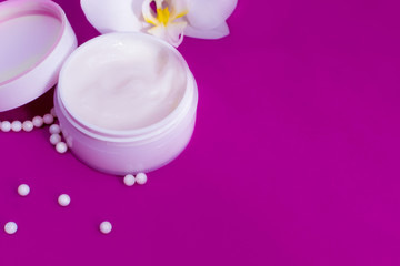 Obraz na płótnie Canvas Gentle soft hand cream in a white jar on a pink background.Skin care, Spa and beauty treatments.Cosmetics for hands.Copy space.Mock up.Close up