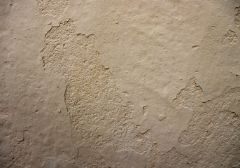 Background of an old painted white surface. Crumbling pale white surface