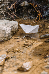 white paper boat in the creek