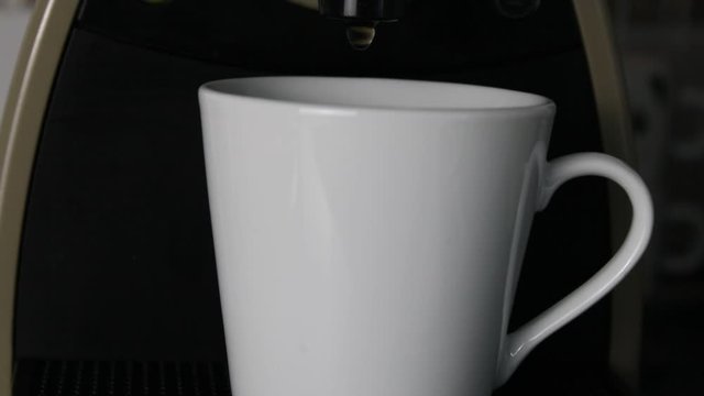 Coffee flowing in a cup.