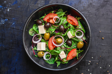 healthy salad
olives, lettuce, tomato and cheese
feta (greek salad, tasty vegetables snack) menu concept background. top view. copy space for text