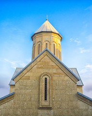 Fototapeta premium Temple of the Georgian Orthodox Church on a background of blue sky