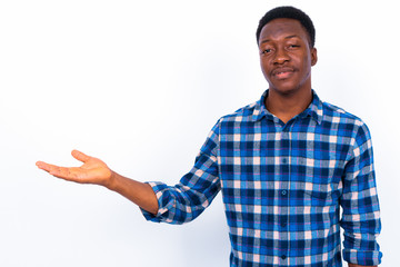 Young handsome African man against white background