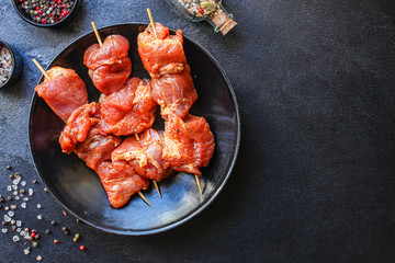 raw meat pork or beef in a plate on the table (preparing healthy food, marinade and spices paprika) menu concept background. top view. copy space for text