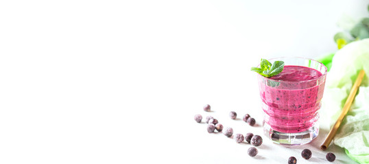 Vitamin smoothie from blackcurrant berries with yogurt and banana in a crystal glass. Healthy eating concept.