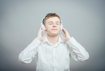 portrait of a young happy man listening to music