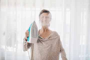 senior woman ironing clothes