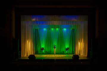 An empty stage of the theater, lit by spotlights before the performance
