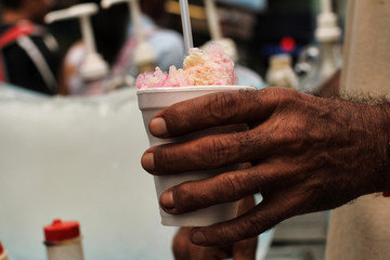Panamanian street worker making ice candy closeup