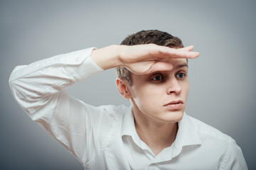 Young smiling man with his hand in the forehead