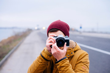 young man photographing on the highway