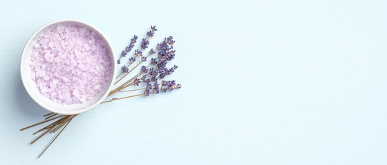 Fototapeta na wymiar Lavender salt with flowers on blue background. Natural organic SPA product, skin care and body treatment concept. Flat lay, top view, copy space